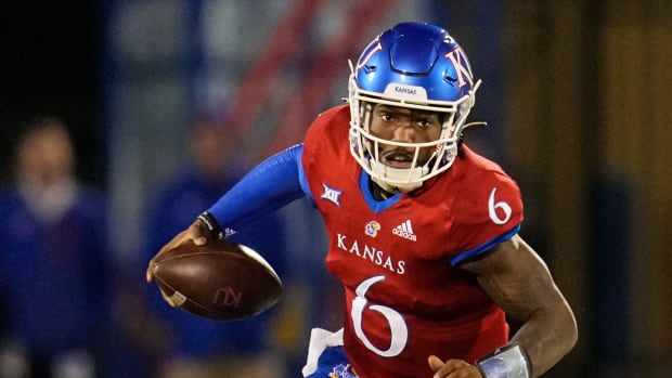 Nov 27, 2021; Lawrence, Kansas, USA; Kansas Jayhawks quarterback Jalon Daniels (6) runs the ball against the West Virginia Mountaineers during the second half at David Booth Kansas Memorial Stadium. Mandatory Credit: Jay Biggerstaff-USA TODAY Sports